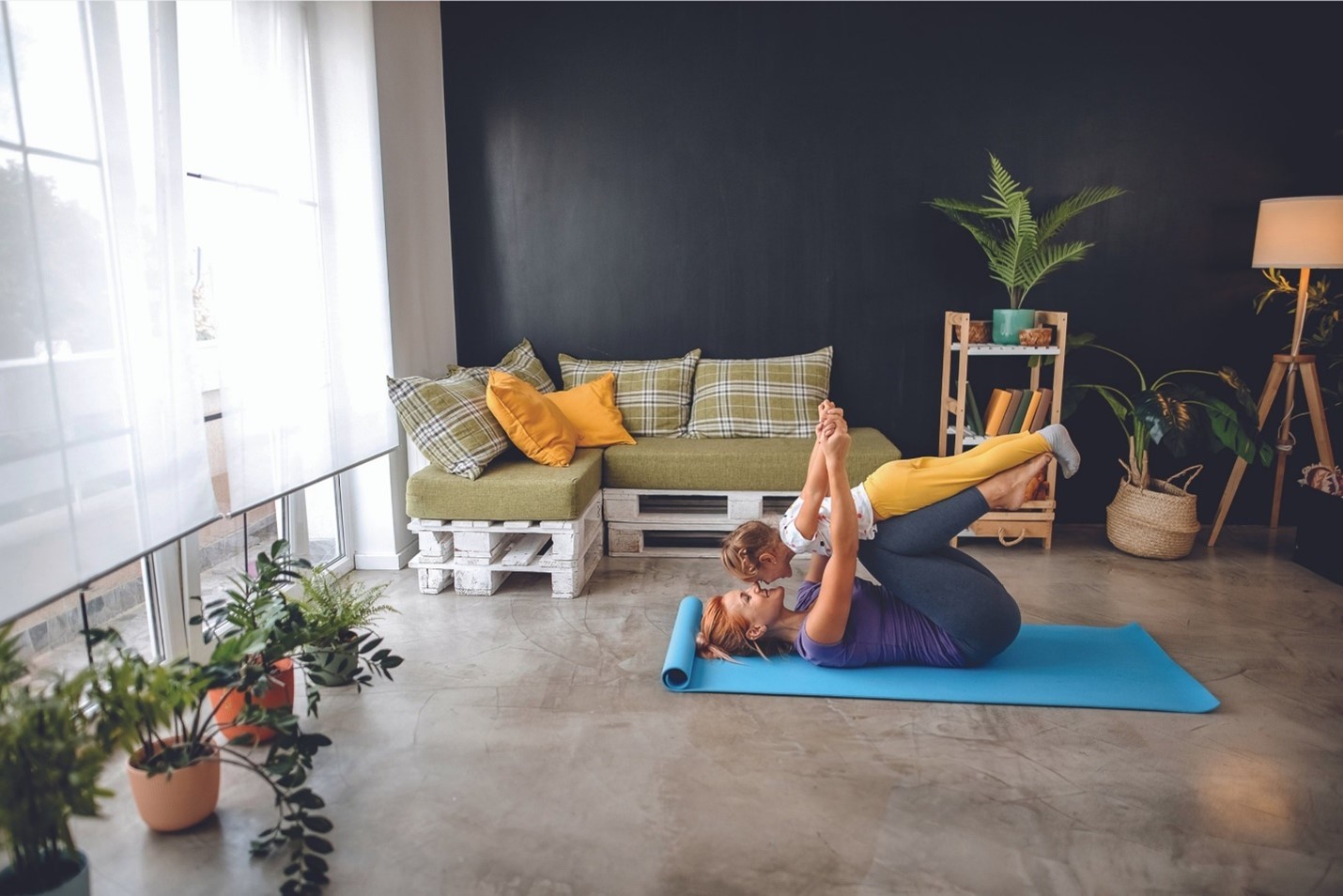 A person and child on a radiant heat floor mat in a room